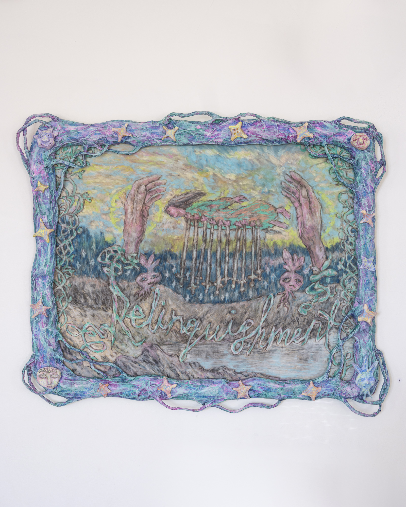 Blue papier mache frame covered in tendrils, stars and faces; within it a colourful drawing of two hands and a woman being impaled by swords, over the word 'Relinquishment' in cursive script.