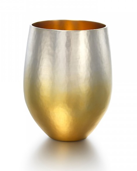 Metal vessel by Colette Bishop, the surface fades from gold at the bottom to silver at the top. Golden interior.